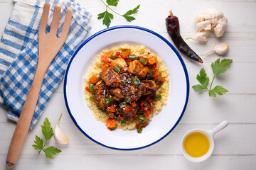 Marinated chicken with vegetables and couscous. Traditional African recipe.
