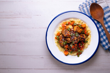 Marinated chicken with vegetables and couscous. Traditional African recipe.
