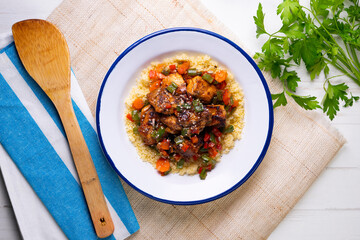 Marinated chicken with vegetables and couscous. Traditional African recipe.