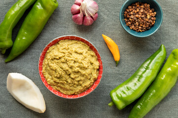 Green pepper and coconut chutney. Main ingredients: green pepper, fresh coconut, chili, garlic and roasted chana dal in bowl.