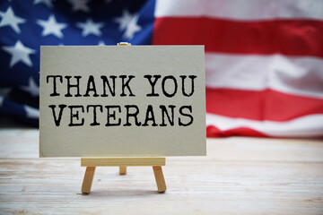 Thank you Veterans text messege  with USA flag on wooden background