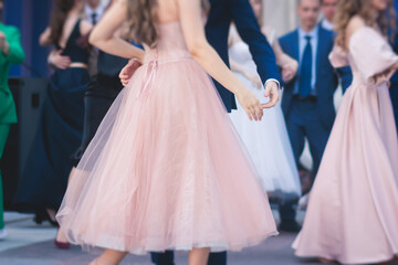 High school graduates dancing waltz and classical ball dance in dresses and suits on school prom graduation, classical ballroom dancers dancing, waltz, quadrille and polonaise