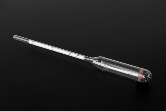 hydrometer, a tool for measuring the density of the battery electrolyte, on a black background