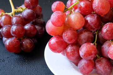 Red grape, Close up red grape on white dish with dew drop use for organic fruit background