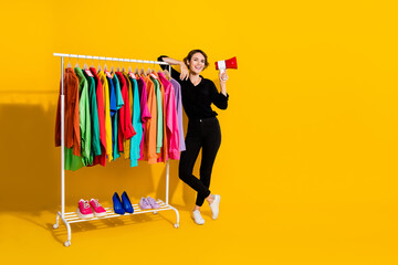 Photo of cheerful cute girl dressed formal shirt sale announcement empty space isolated yellow...