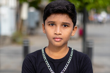 Cute Boy style poses with black t-shirt and jean pant with big silver chain - boy neckless