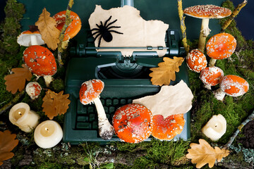 Fly agaric mushrooms are located on a retro typewriter and around on green moss. Mockup. Space for...