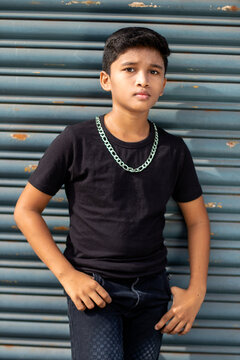 Cute Boy Style Poses With Black T-shirt And Jean Pant With Big Silver Chain - Boy Neckless - Background Metal Shutter 