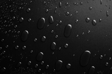 Water drops on a black background. Banner with raindrops. Top view.