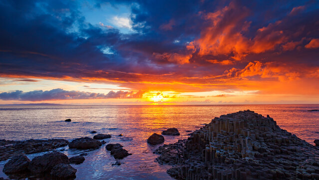 sunset over the sea at Gaint&acute;s Causeway in Ireland