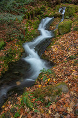 Stunning waterfall landscape image in vibrant Autumn woodland in Lake District