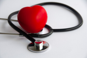 Stethoscope with heart shape on white background. Copy space and health concept