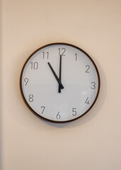 Eleven oclock 11am 11pm on traditional analogue clock on wall