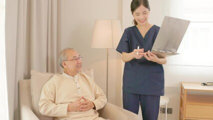 Senior elderly guy patient chatting to caring female doctor physician caregiver at nursing home in hospital holding hands describing well-being receiving support and medicare services during medical c