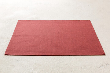 Perspective view of red tablecloth for food on cement background. Empty space for your design