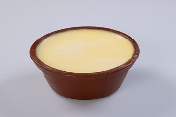 delicious misti doi is a Bengali dessert in a mud pot isolated on white background