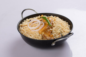 Chicken biryani , bangladeshi style chicken dhum biriyani made using chinigura rice and spices arranged in a black bowl with white background, isolated
