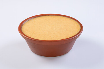 delicious misti doi is a Bengali dessert in a mud pot isolated on white background