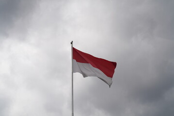 Indonesian Flag in the cloudy gray sky