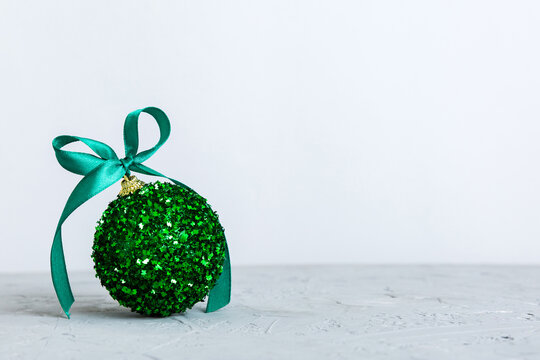 Christmas ball on colored background. decoration bauble with ribbon bow with copy space