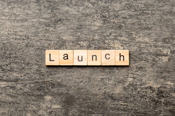 launch word written on wood block. launch text on table, concept