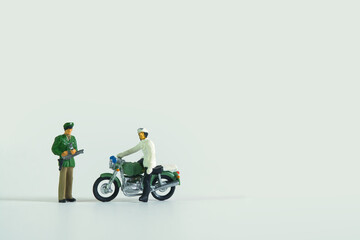 Policeman on a motorcycle in front of a colleague isolated on white background