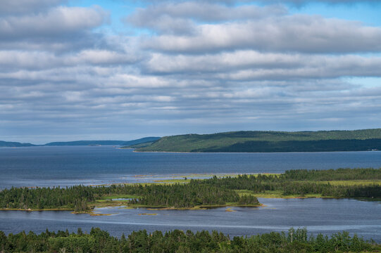 Canada, Newfoundland - Labrador, Lumsden, White puffy clouds over ocean coast