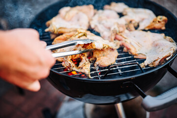 man chef cooking chicken meat on grill outdoor