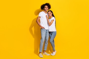 Full size portrait of two peaceful idyllic people cuddle toothy smile isolated on yellow color background