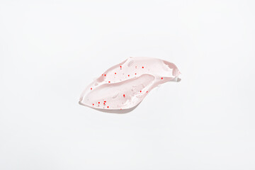 Skin care concept moisturising gel with exfoliating particles top view on ligt surface