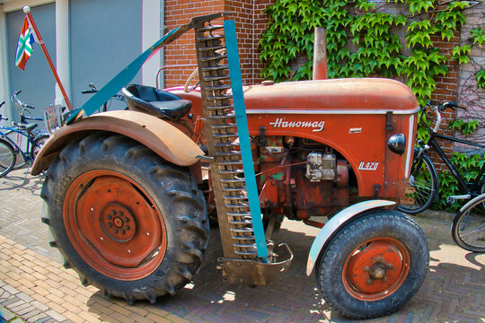 Uithuizen, Netherlands, 5-21-2022. Vintage Hanomag R420 tractor with disc harrow at a classic car show in Uithuizen, Groningen, the Netherlands.
