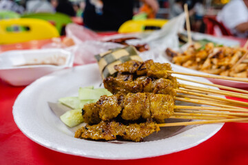 Satay - Malaysia and Singapore traditional hawker food,  seasoned, skewered and grilled meat,...