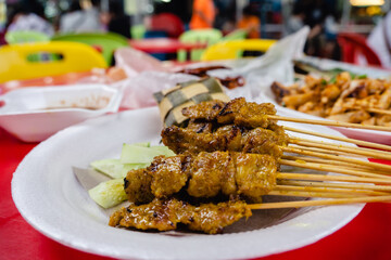 Satay - Malaysia and Singapore traditional hawker food,  seasoned, skewered and grilled meat,...