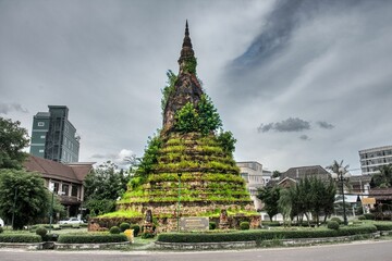 Stupa in Vientiane City, That Dam Stupa, Lao PDR South East Asia, HDR Picture, green Stupa with blue dramatic sky. High quality photo