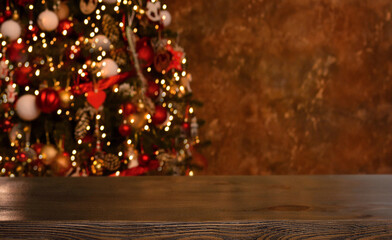 Christmas background. Empty wooden table on the background of the Christmas tree and New Year's bokeh.Ready for product montage.Mockup.