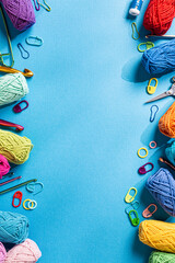 Crochet blue background with cotton yarn, crochet hooks and accessories. Flat lay overhead shot with copy space