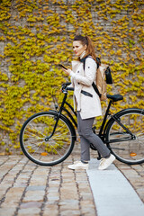 Obraz premium elegant woman sending text message using phone outside in city