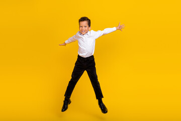 Fototapeta na wymiar Full body photo of overjoyed crazy person jumping have fun isolated on yellow color background