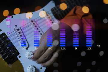Hands are twisting the volume knobs of an electric guitar and there's a frequency graphic showing how loud the sound or sound pressure in decibel A scale. - obrazy, fototapety, plakaty