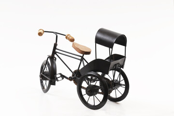 Naklejka na ściany i meble Decorative souvenir bike. Antique tricycle-carriage. Shallow depth of field