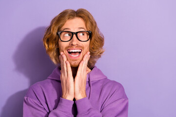 Photo of impressed wavy red hairstyle guy look promo wear spectacles purple sweatshirt isolated on...