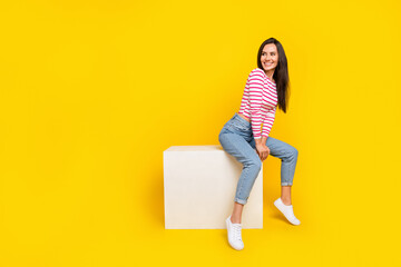 Photo of nice cute girl straight hairdo dressed striped shirt jeans sitting on cube look empty...