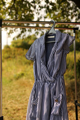 A gray striped robe hangs on a hanger.