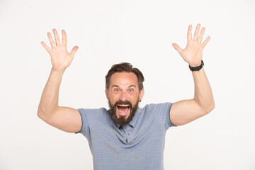 Bearded handsome man feeling happy, amazed, lucky and surprised, celebrating victory with both hands up in the air isolated white background