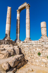 A close up of the front columns of the Temple of Hercules in the citadel in Amman, Jordan in summertime