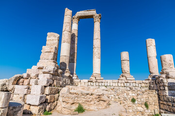 Fototapeta na wymiar A close up of the front columns and wall of the Temple of Hercules in the citadel in Amman, Jordan in summertime