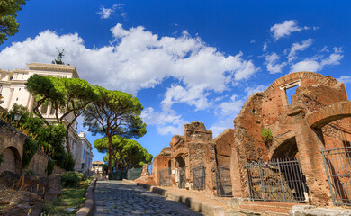 Obraz premium View of Clivus Argentarius, a road of ancient Rome: it preserves a section of the ancient paving and traces of the brick rooms that flanked it.