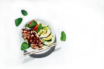 top view of a salad with meat vegetables and fruits seasoned with sauce on a beige background with free space for text