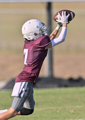 Young athletic tackle football players making great plays during a game