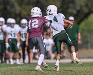 Young athletic tackle football players making great plays during a game